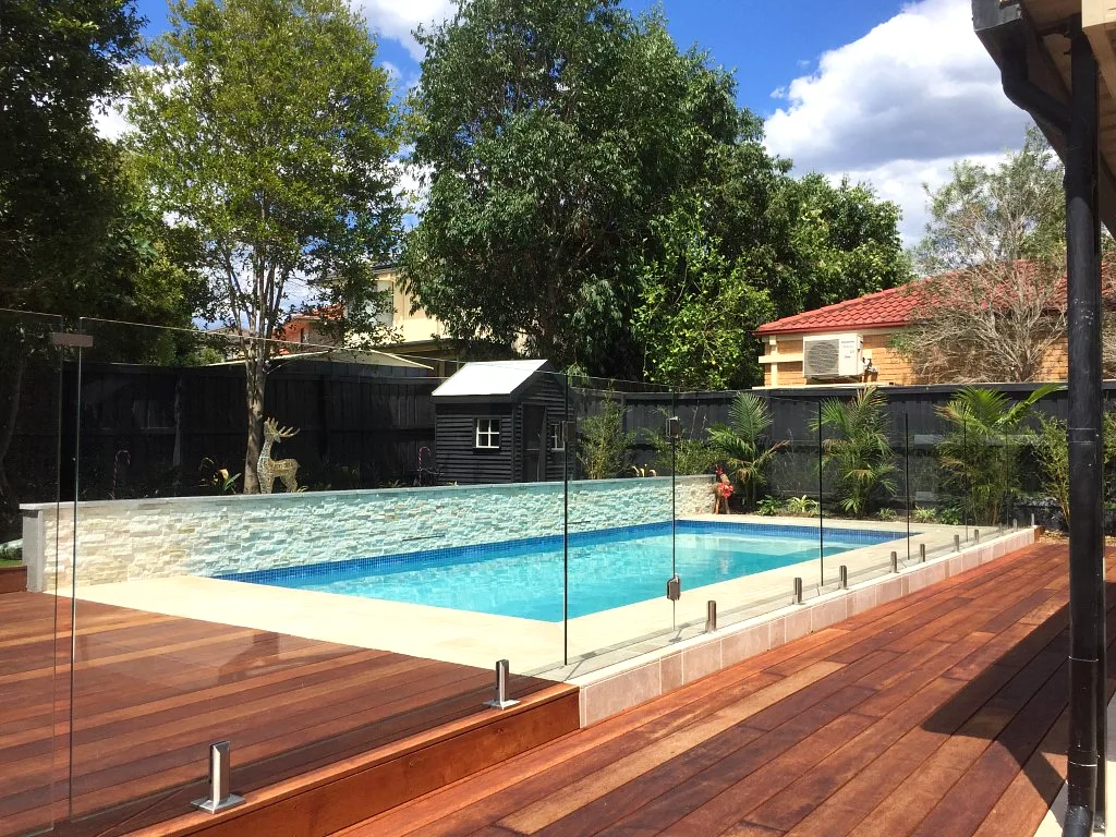 Finished glass pool fence around a Sydney swimming pool
